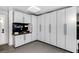 Garage featuring custom cabinets with black hardware, epoxy floors, and a slat wall for organized storage at 8316 Maplestar Rd, Las Vegas, NV 89128
