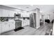 The kitchen features stainless steel appliances, white cabinets and mosaic backsplash at 8316 Maplestar Rd, Las Vegas, NV 89128