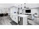 Modern kitchen flows to the living area, showcasing the open concept and functionality at 8316 Maplestar Rd, Las Vegas, NV 89128