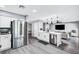 Open kitchen with stainless steel refrigerator and a breakfast bar area at 8316 Maplestar Rd, Las Vegas, NV 89128