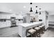 Bright kitchen featuring white cabinets, stainless steel appliances, and a breakfast bar at 8316 Maplestar Rd, Las Vegas, NV 89128