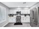 Modern kitchen features stainless steel appliances, white cabinets, and ample counter space at 8316 Maplestar Rd, Las Vegas, NV 89128