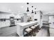 Bright kitchen featuring white cabinets, stainless steel appliances, and a breakfast bar at 8316 Maplestar Rd, Las Vegas, NV 89128