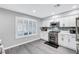 Spacious kitchen with stainless appliances, white cabinets and mosaic tile backsplash at 8316 Maplestar Rd, Las Vegas, NV 89128