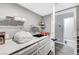 Well-organized laundry room with white cabinets, shelves, and counter space, providing ample storage at 8316 Maplestar Rd, Las Vegas, NV 89128
