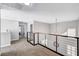 Bright loft area with modern railing, neutral carpet, and ample natural light at 8316 Maplestar Rd, Las Vegas, NV 89128