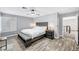 Relaxing main bedroom featuring stylish furnishings, wood-look floors, and ample natural light at 8316 Maplestar Rd, Las Vegas, NV 89128