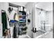 Spacious walk-in closet that leads to an elegant bathroom with glass shower and modern tub at 8316 Maplestar Rd, Las Vegas, NV 89128
