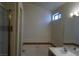 Bathroom featuring a tub and shower combination with tile surround and small window at 8332 Shore Breeze Dr, Las Vegas, NV 89128