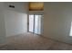 Bright bedroom with sliding glass door and plush carpeting at 8332 Shore Breeze Dr, Las Vegas, NV 89128