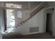 Bright entryway features tile flooring and a staircase with plush carpeting at 8332 Shore Breeze Dr, Las Vegas, NV 89128