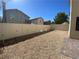 Large fenced backyard with gravel and paved area, offering a private outdoor space at 8566 Bright Bush St, Las Vegas, NV 89131