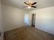 Spacious carpeted bedroom featuring a ceiling fan, closet, and ensuite bathroom access at 8566 Bright Bush St, Las Vegas, NV 89131