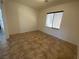 Neutral bedroom featuring tile flooring, one window, and ample space at 8566 Bright Bush St, Las Vegas, NV 89131