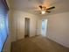 Bedroom featuring ceiling fan, closet, carpet flooring, and ensuite bathroom access at 8566 Bright Bush St, Las Vegas, NV 89131