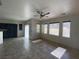 Open concept living room with lots of windows, tile floors, and ceiling fan at 8566 Bright Bush St, Las Vegas, NV 89131