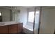 Bathroom featuring a double vanity, framed mirror, soaking tub with a showerhead, and a separate standing shower at 8695 Canfield Canyon Ave, Las Vegas, NV 89178