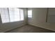 Bright bedroom with large window and modern gray laminate flooring at 8695 Canfield Canyon Ave, Las Vegas, NV 89178