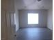 This bedroom has a ceiling fan, a window for natural light, and dark wood-look flooring at 8695 Canfield Canyon Ave, Las Vegas, NV 89178