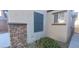 Home exterior showcasing stone accents, a window with dark shutters and landscaping at 8695 Canfield Canyon Ave, Las Vegas, NV 89178