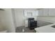Bright kitchen with white cabinets, sleek countertops, and modern black range at 8695 Canfield Canyon Ave, Las Vegas, NV 89178