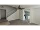 Open-concept living space with views to the kitchen and stairway at 8695 Canfield Canyon Ave, Las Vegas, NV 89178