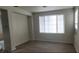 Open living room with a large window and laminate flooring at 8695 Canfield Canyon Ave, Las Vegas, NV 89178