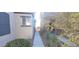 Narrow side yard with desert landscaping and a walkway at 8695 Canfield Canyon Ave, Las Vegas, NV 89178