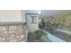 Side yard of home with stone accent wall and desert landscaping at 8695 Canfield Canyon Ave, Las Vegas, NV 89178
