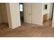 Bedroom featuring neutral carpeting, leading to a bathroom with a vanity, and access to other rooms in the home at 8749 Brilliant Star Dr, Las Vegas, NV 89178