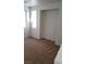 Bright bedroom featuring fresh carpeting, two windows, and a recessed alcove at 8749 Brilliant Star Dr, Las Vegas, NV 89178