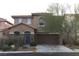 Two-story home with a two-car garage and a neutral color scheme for a clean, modern look at 8749 Brilliant Star Dr, Las Vegas, NV 89178