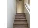 Carpeted stairway with white banister offers a smooth transition to the upper level of the home at 8749 Brilliant Star Dr, Las Vegas, NV 89178