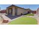 A cozy backyard with artificial grass, brick patio, and rock landscape at 9120 Parkstone Ave, Las Vegas, NV 89178