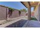 Backyard view with covered patio, brick walls, and rock landscaping at 9120 Parkstone Ave, Las Vegas, NV 89178