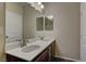 Bathroom with double sink vanity, mirror, and tile flooring at 9120 Parkstone Ave, Las Vegas, NV 89178