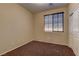 Clean bedroom with neutral walls, carpet, and natural light at 9120 Parkstone Ave, Las Vegas, NV 89178