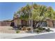 Beautiful single-story home featuring desert landscaping, stone accents, and mature trees at 9120 Parkstone Ave, Las Vegas, NV 89178