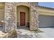 Close-up of the front door showcasing stone detail and craftsman design at 9120 Parkstone Ave, Las Vegas, NV 89178