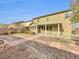 Large backyard featuring a covered patio area and desert landscaping with stone accents at 9609 Rolling Thunder Ave, Las Vegas, NV 89148