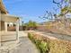 Backyard featuring desert landscaping, covered patio, and partial privacy fence at 9609 Rolling Thunder Ave, Las Vegas, NV 89148