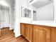Bathroom with wood cabinets, vanity, sink, and a large mirror at 9609 Rolling Thunder Ave, Las Vegas, NV 89148