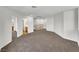 Bonus room featuring neutral carpet and access to bathroom and stairs at 9609 Rolling Thunder Ave, Las Vegas, NV 89148