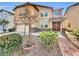Charming two-story home featuring stone accents, double-door entry, and well-manicured landscaping at 9609 Rolling Thunder Ave, Las Vegas, NV 89148