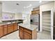 Kitchen featuring granite counters, stainless refrigerator, and center island at 9609 Rolling Thunder Ave, Las Vegas, NV 89148