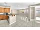 Open concept kitchen and living area featuring tile floors and granite countertops at 9609 Rolling Thunder Ave, Las Vegas, NV 89148