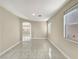 Bright living room with tile flooring and multiple windows at 9609 Rolling Thunder Ave, Las Vegas, NV 89148