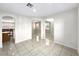 Open living room with tile flooring and an arched entryway and access to the kitchen at 9609 Rolling Thunder Ave, Las Vegas, NV 89148
