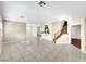 Bright living room features tile flooring, and stairway to the second floor at 9609 Rolling Thunder Ave, Las Vegas, NV 89148