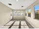 Inviting sunroom featuring tile floors, neutral walls, many windows, and a glass patio door at 9609 Rolling Thunder Ave, Las Vegas, NV 89148